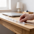 Clear adhesive clips guide a cable along a desk edge